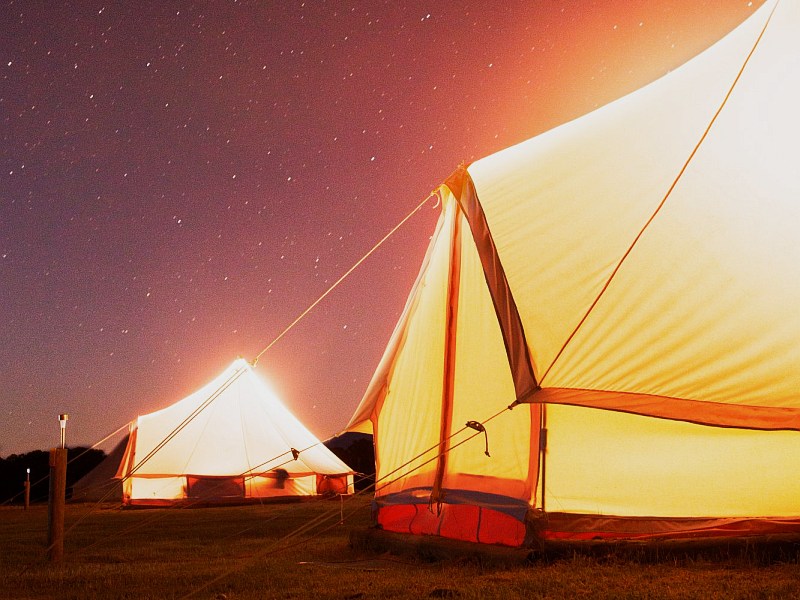 Glamping bell tent lit up from inside